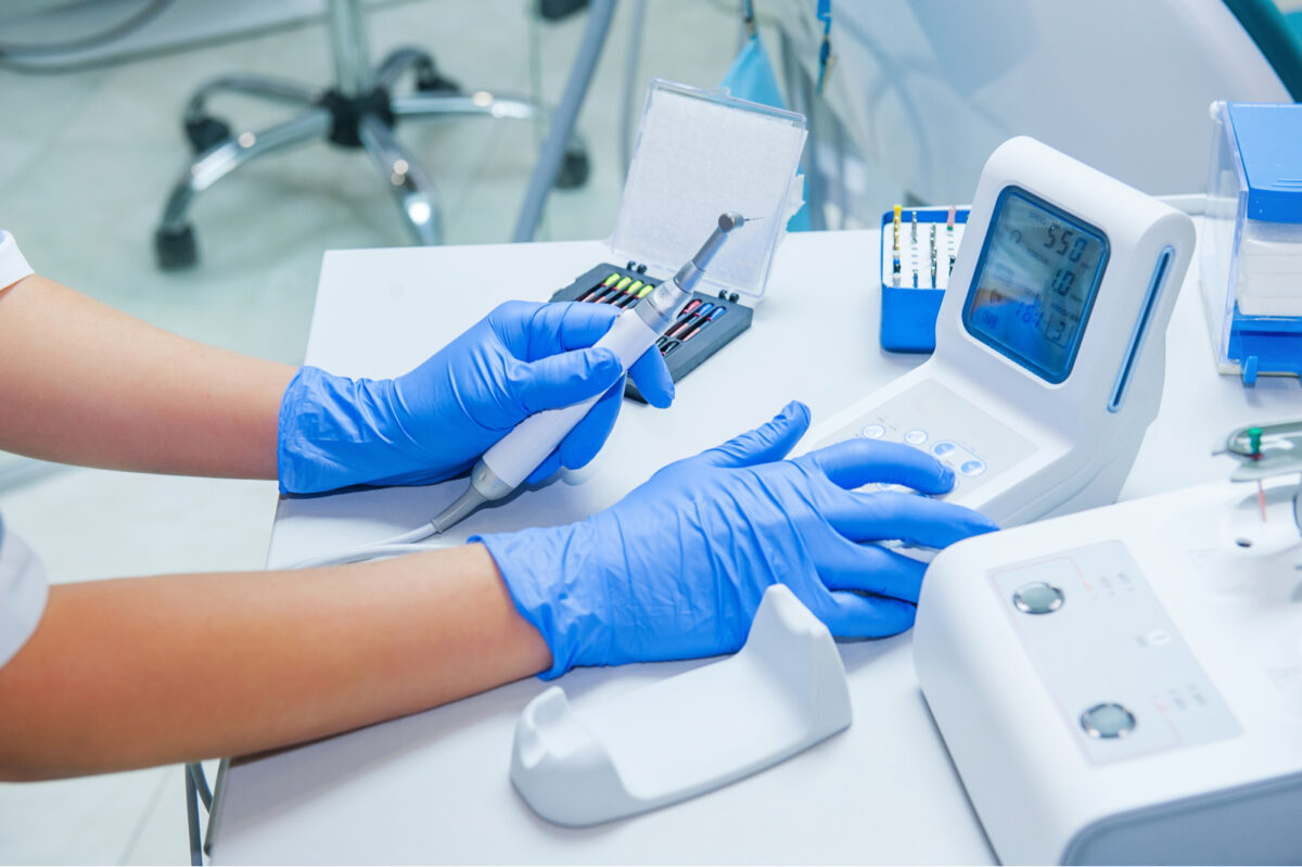 Assistant's hands configures dental equipment